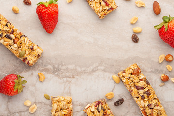 Fototapeta premium granola bars with nuts and strawberries on a light background with space for design, horizontal photo, diet, proper nutrition