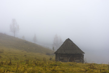 Autumn landscape with traditional houses in Fundatura Ponorului, also known as "The palm of God", Sureanu Mountains, Romania