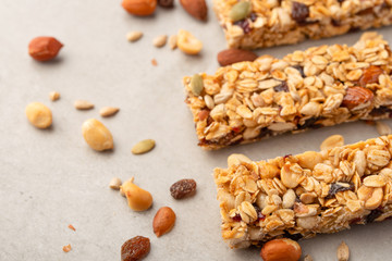 granola bars with nuts on a light background with space for design, horizontal photo, diet, proper nutrition