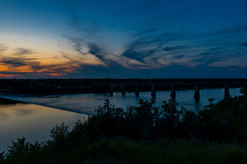 Sunset by the CN Train bridge over teh South Saskatchewan River in Saskatoon Saskatchewan Canada