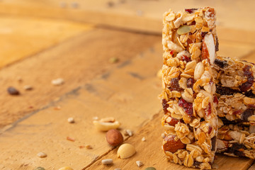 granola bars and nuts on a wooden background with space for design, horizontal photo, diet, proper...