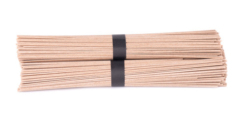 Soba noodles, isolated on white background. Bundle of buckwheat japanese soba noodle sticks. Asian food.