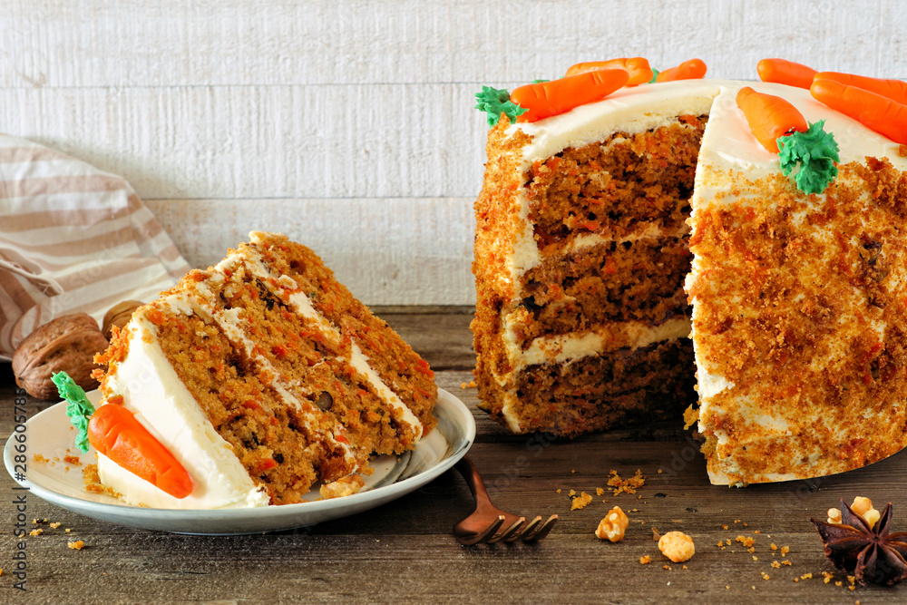 Poster slice of homemade carrot cake with cream cheese frosting and fondant carrots. side view table scene 