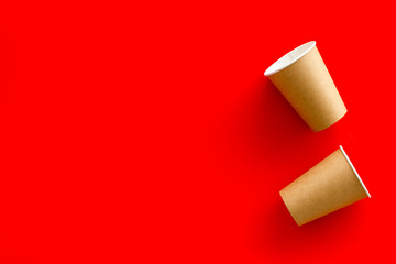 paper cups for coffee to take away on red background copyspace