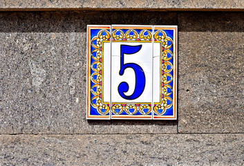 Five, number 5, decorative digit on pale background.