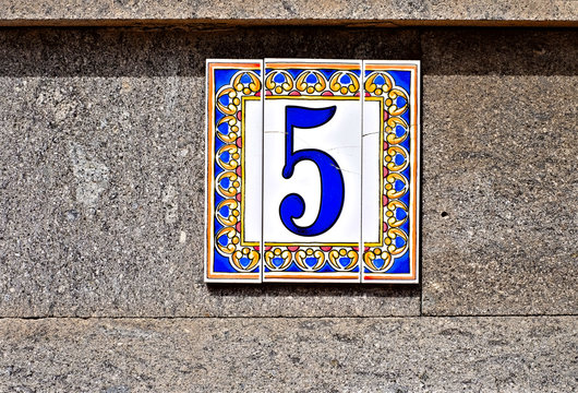 Five, number 5, decorative digit on pale background.