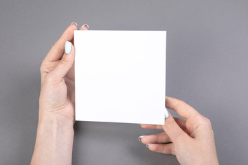 A woman holding white booklet