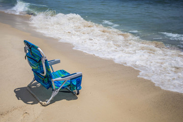 Lone empty chair at the beach