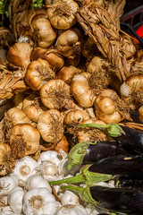 Smoked garlic bulbs for sale on a market stall