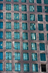 Fototapeta na wymiar Reflections in the windows of a downtown high rise.