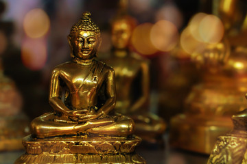 background of golden buddha statue with bokeh