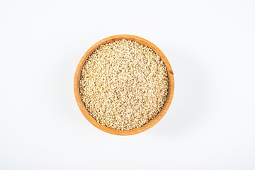 A wooden bowl of miscellaneous grains buckwheat on a white background