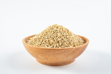 A wooden bowl of miscellaneous grains buckwheat on a white background