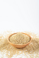 A wooden bowl of miscellaneous grains buckwheat on a white background