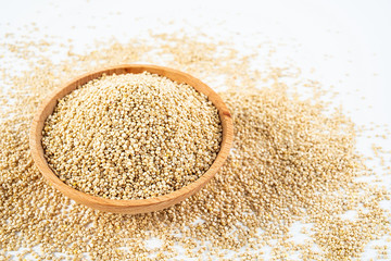 A wooden bowl of miscellaneous grains buckwheat on a white background