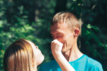 A guy and a girl are walking in the park