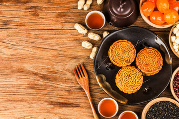Traditional mooncakes on table setting with teacup.
