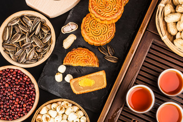 Traditional mooncakes on table setting with teacup.