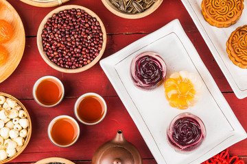 Traditional mooncakes on table setting with teacup.