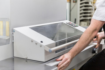 Printer dialling in specification of paper to be cut perfectly by guillotine.