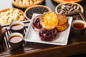 Traditional mooncakes on table setting with teacup.