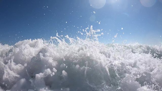 Group of family and friends riding a wave together on boogie boards at the beach on vacation in California.