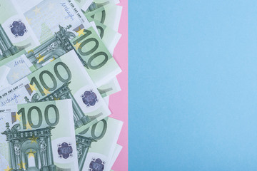 Euro cash on a blue and pink background. Euro Money Banknotes. Euro Money. Euro bill. Place for text.