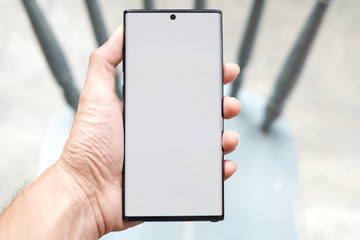  The man's hand is holding a New smartphone.