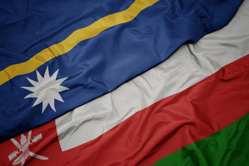 waving colorful flag of oman and national flag of Nauru .
