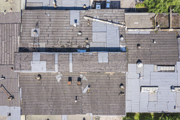 drone aerial view of warehouse at industrial area with old weathered roof 