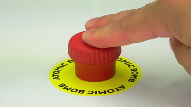 Atomic bomb button for launch or stop reaction. Hand pushing button to fire missile.