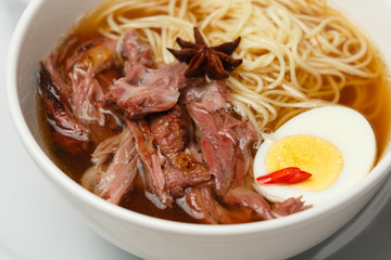 a beef and noodle soup with eggs