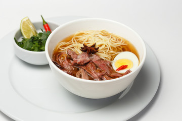 a beef and noodle soup with eggs