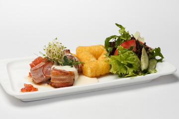 sauce medallions with cheese sticks and a vegetables