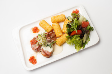 sauce medallions with cheese sticks and a vegetables