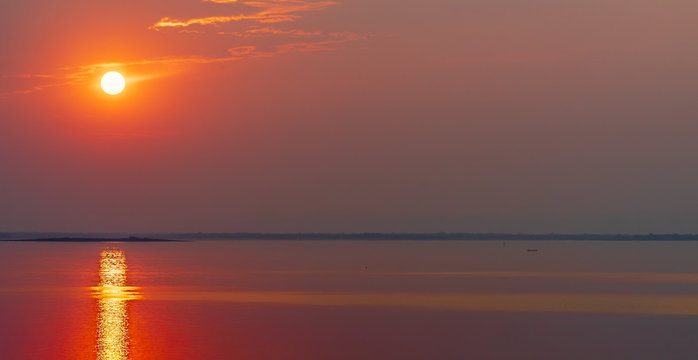 Fishermen are fishing in the lake. on holidays when the sun sets. golden sun light with reflections on the lake. concept