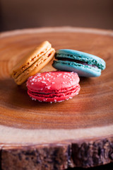 Macaroons close up on wood platter