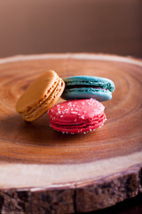 Macaroons close up on wood platter