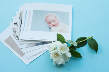 printed photos of baby. Orenburg Russia 17.06.19. photography cards, background with a white flower. Mock up