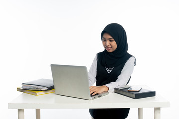 Happy cheerful asian woman working on laptop computer