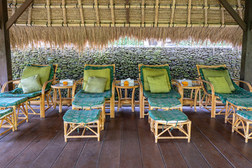Massage table overlooking the tropical garden. Spa massage room with foot massage chairs on island Bali, Indonesia