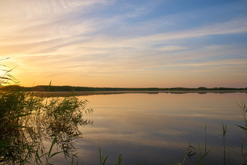magnificent sunrise over distant forest and pond