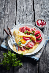 close-up of Crepes with fried egg, ham