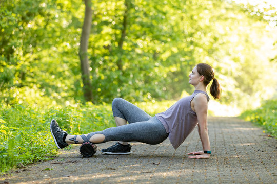 Young woman is doing fitness with a blackroll