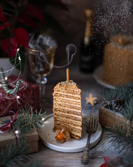 Homemade honey cake. Winter composition. New Year photo. Christmas decoration. Christmas decorations. Cake with sparklers. Candles. Snow