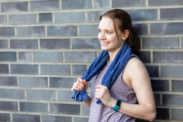 Young jogger with a towel in nature