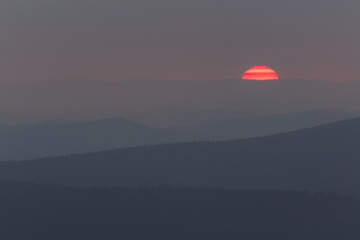 Detail of sunset with distant hill from Tristolicnik. Outdoor and landscape background. Sumava National Park and Bavarian Forest, Czech republic and Germany