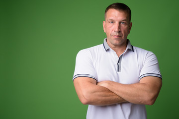 Portrait of macho mature man with arms crossed