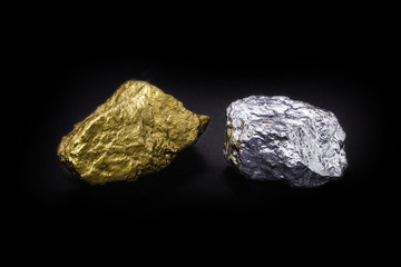 Gold and silver nuggets on black background. Precious stones, luxury concept and mineral drainage. Industrial activity, treasure and fortune.