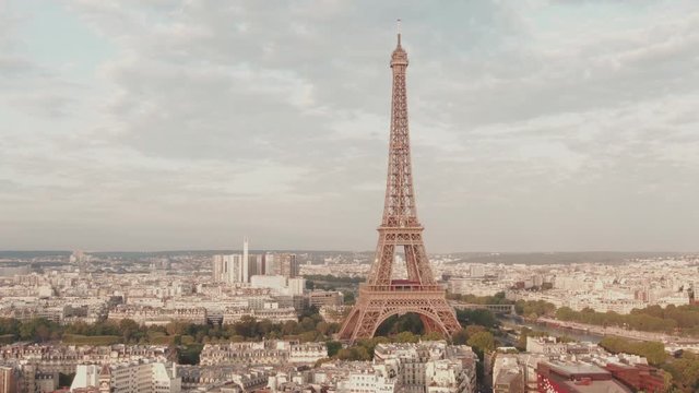 Aerial drone shot of the famous Eiffel Tower in Paris, France while it is being light by the morning sun